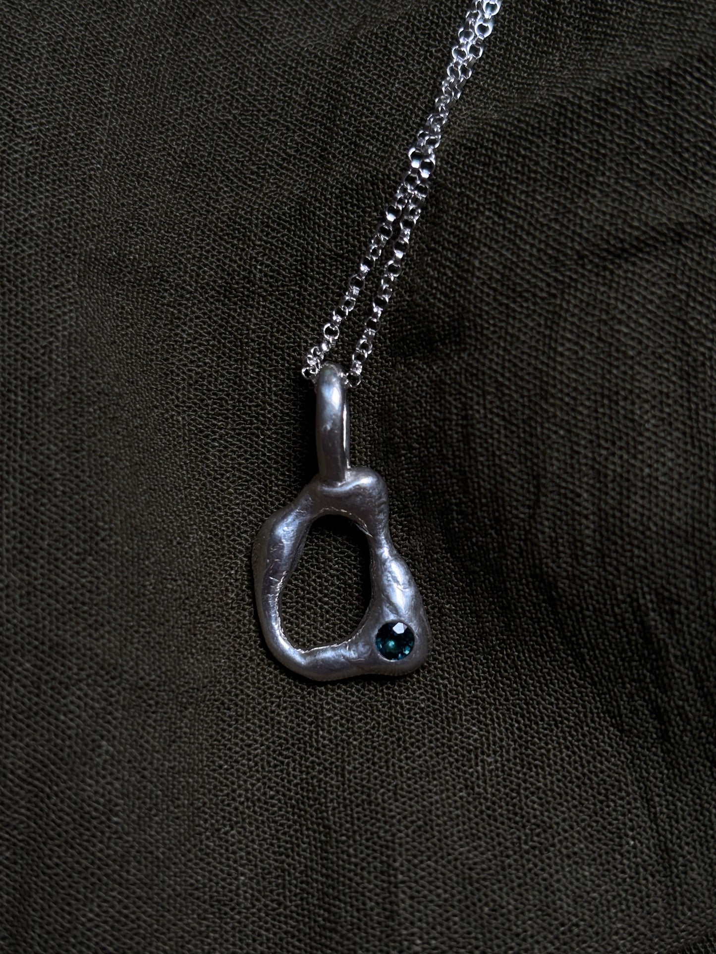 Molten pendant with sapphire
